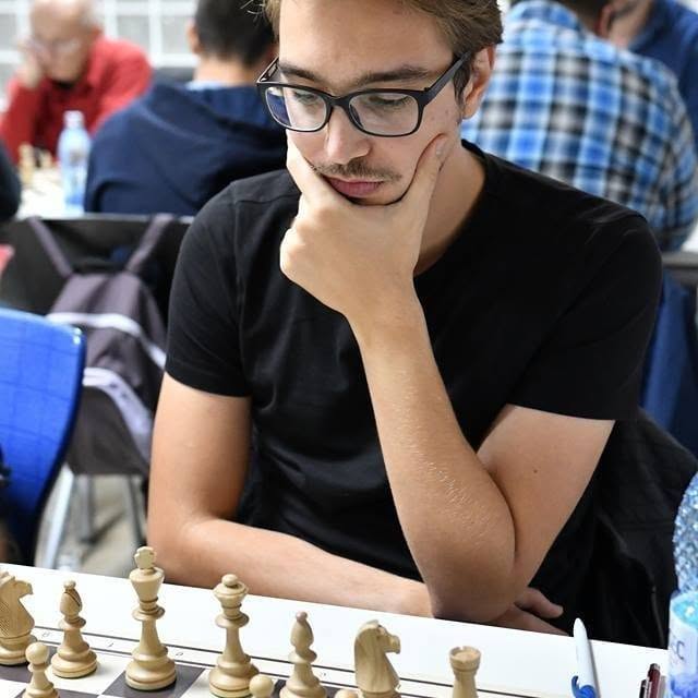Mircea concentrating over a chessboard during a tournament